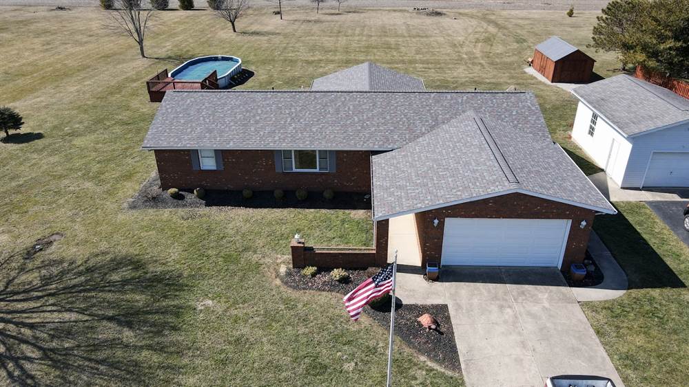 Finished brick ranch roof replacement with the flag flying out front